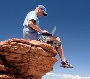 Man in wilderness on laptop